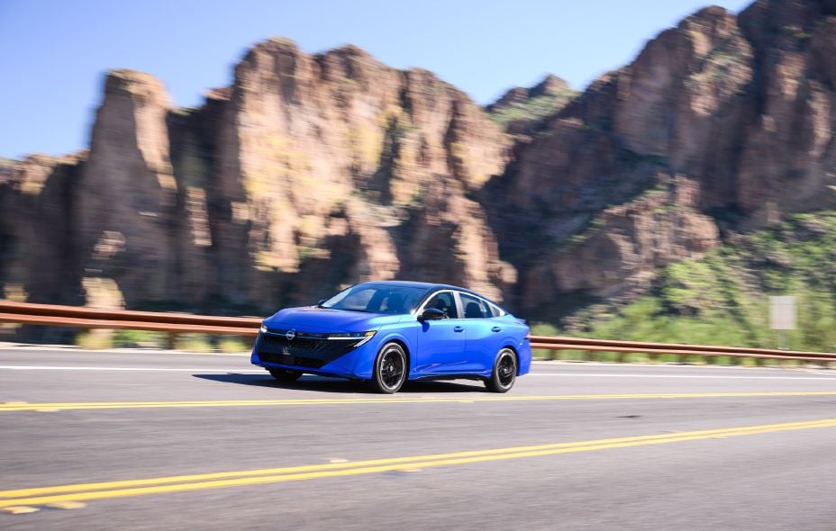 Official Nissan photo of a blue 2027 Nissan Sentra SR driving on a desert mountain highway
