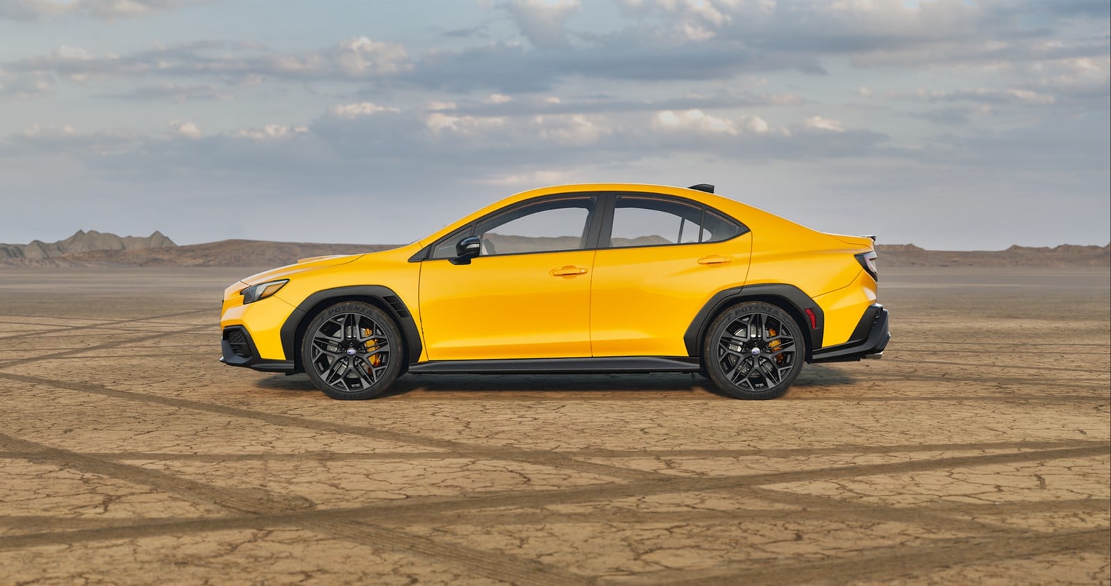 Official Subaru photo of a 2026 Subaru WRX Series.Yellow in side profile on a dry lakebed