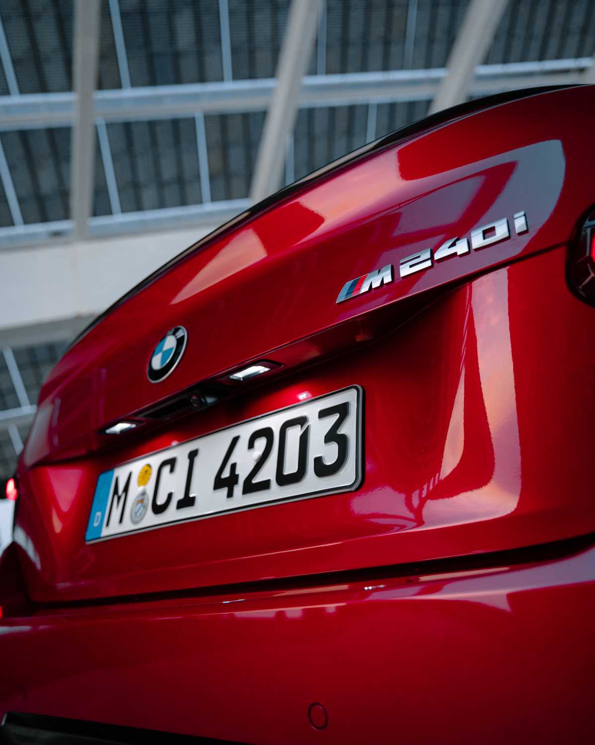 Official BMW press photo detail of the M240i badge on the trunk lid