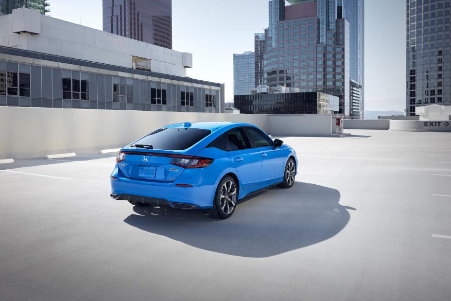 Official Honda photo of a Civic Hatchback Sport Touring Hybrid rear three-quarter on a rooftop