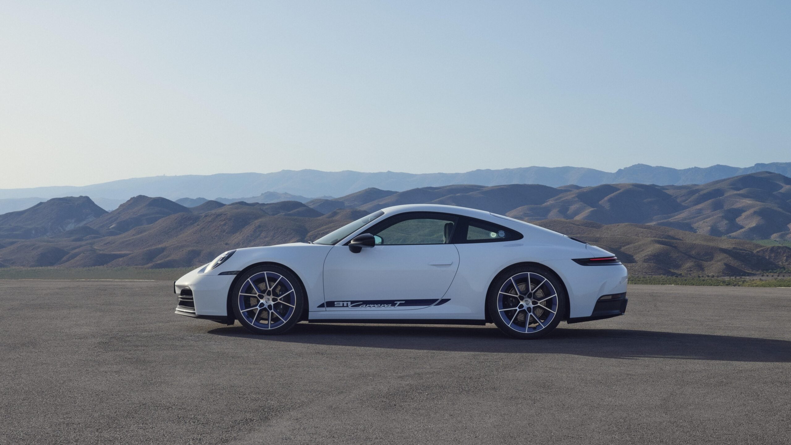 Official Porsche photo of white 2027 911 Carrera T side profile with 911 Carrera T door graphic