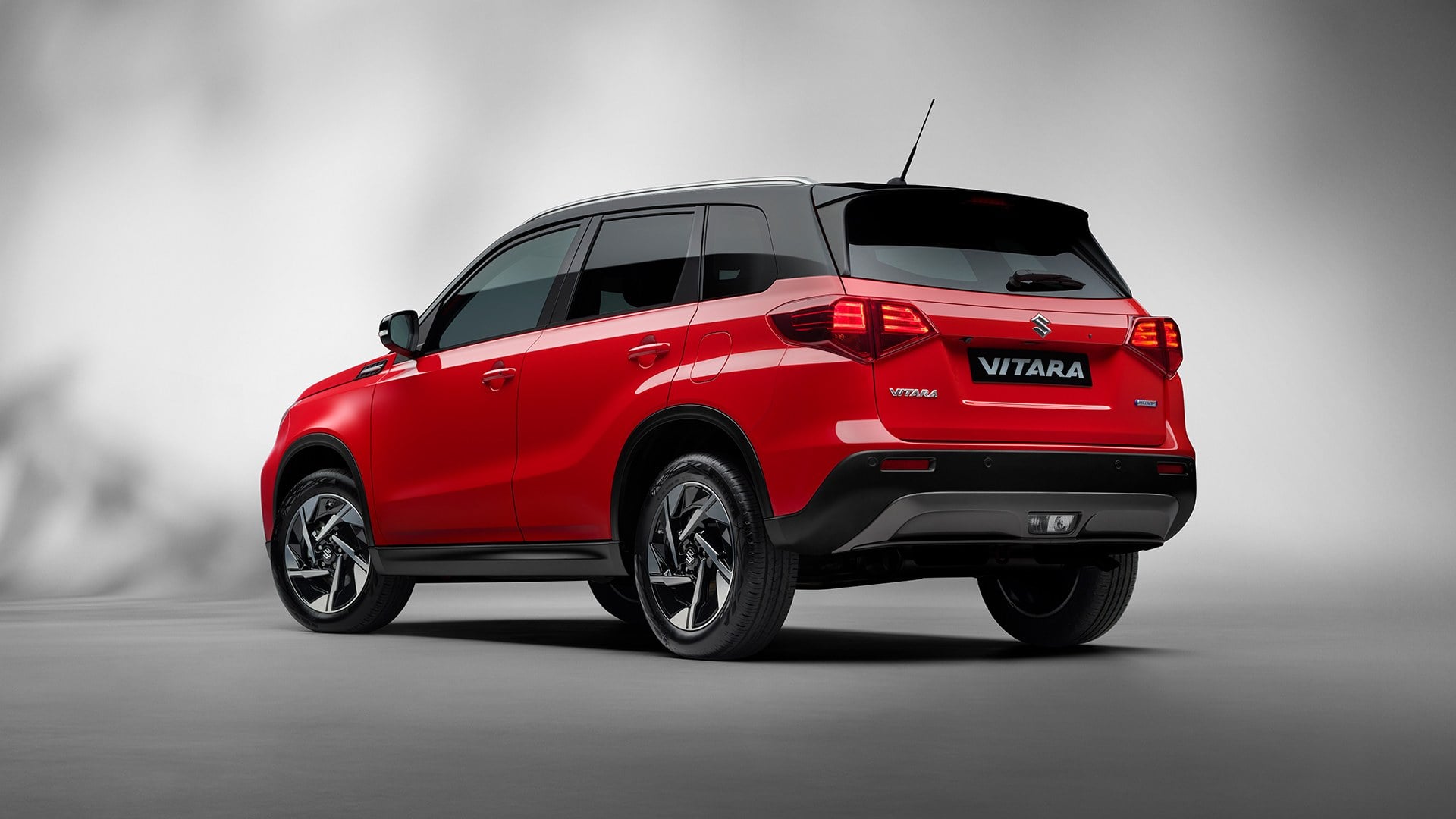 Official Suzuki GB photo of a red Suzuki Vitara, rear three-quarter view