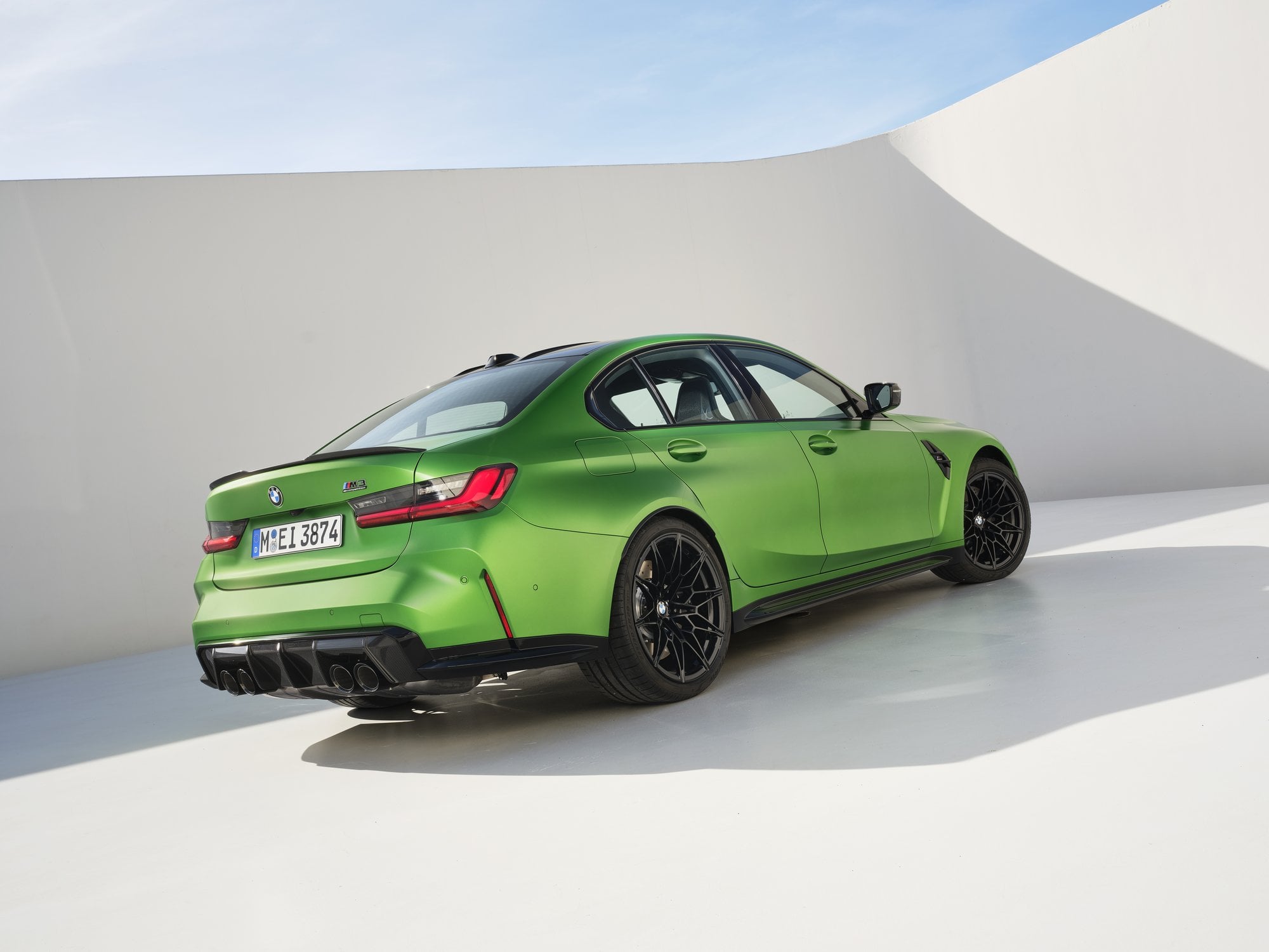 Official BMW press photo of the BMW M3 Sedan rear three-quarter with quad exhaust tips