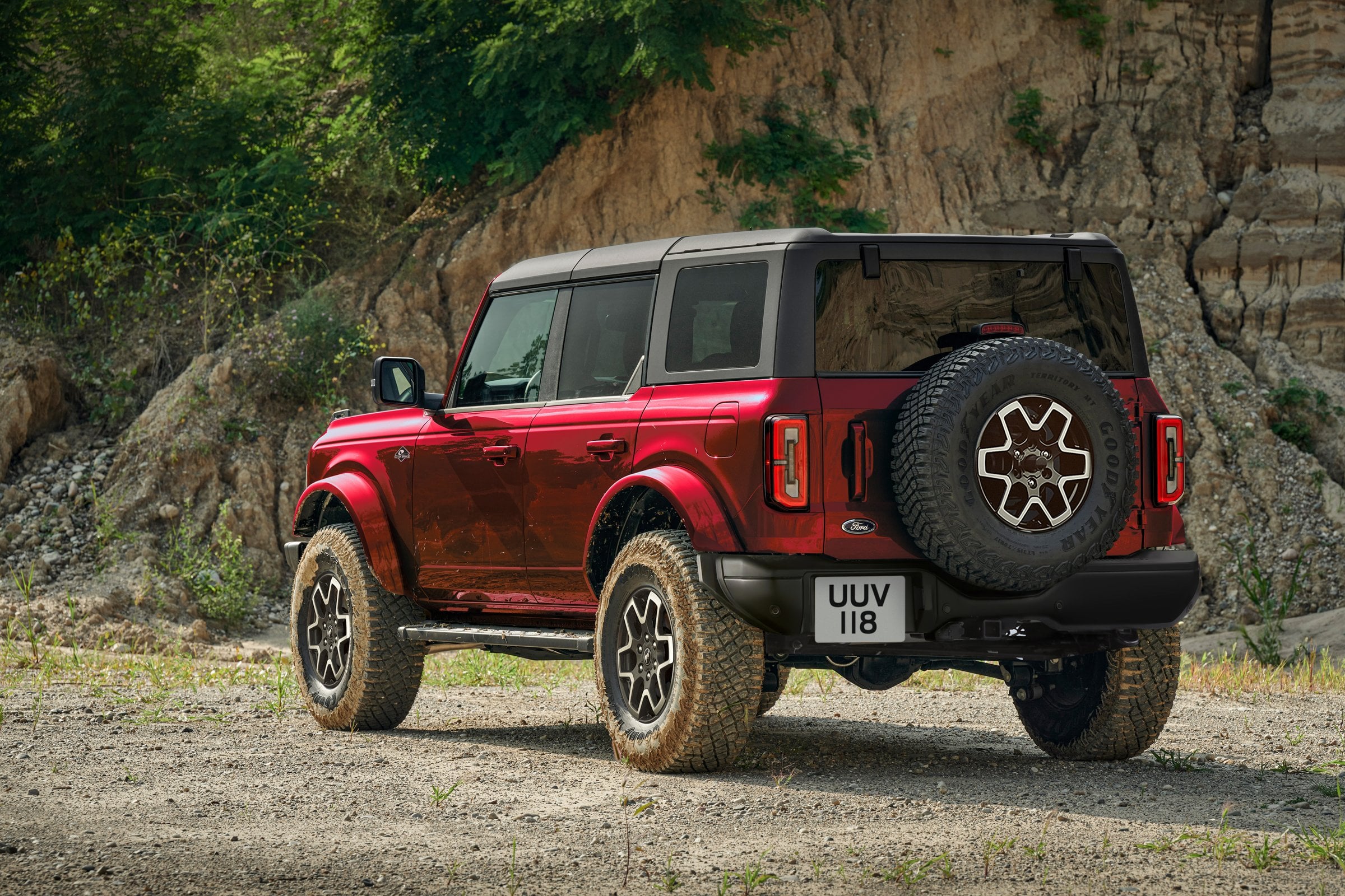 Official Ford press photo of a red two-door Ford Bronco parked on rocky ground