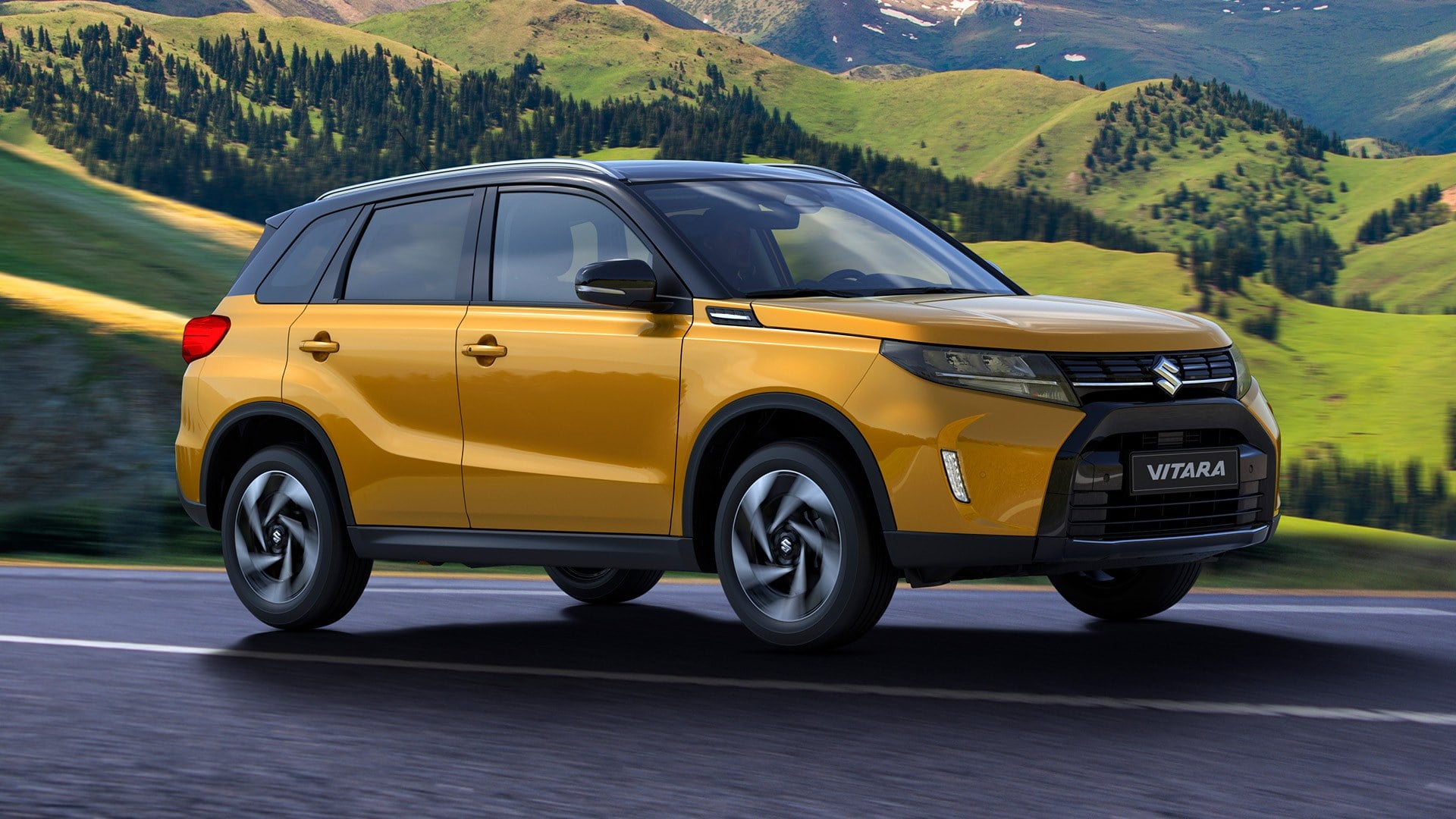 Official Suzuki GB photo of a Solar Yellow Suzuki Vitara with a black roof on a mountain road
