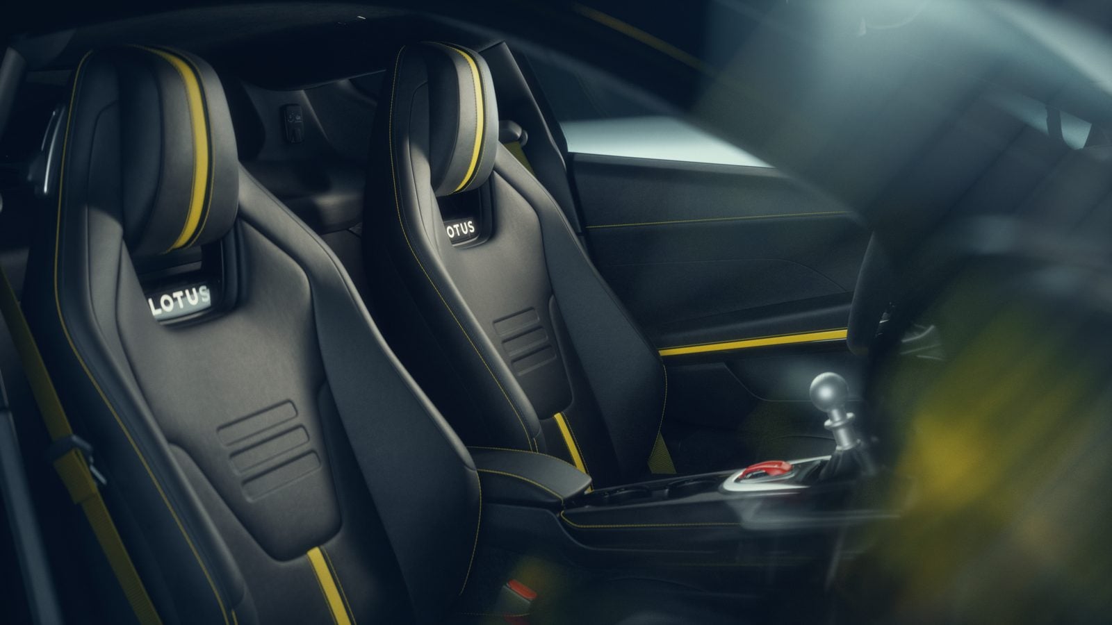 Official Lotus photo of the Emira V6 SE sport seats with the manual shifter between them