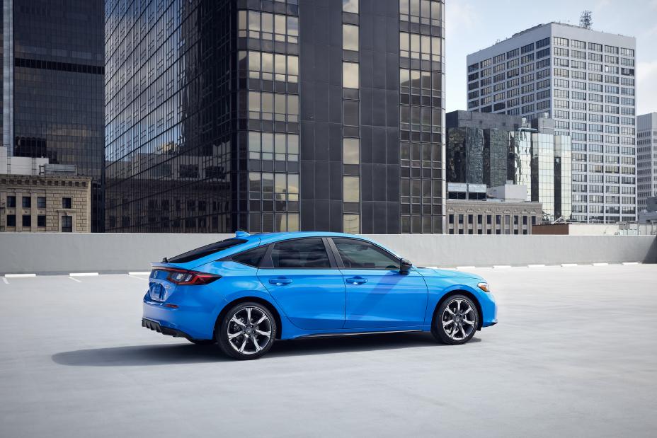 Official Honda photo of a Civic Hatchback rear three-quarter against a city skyline