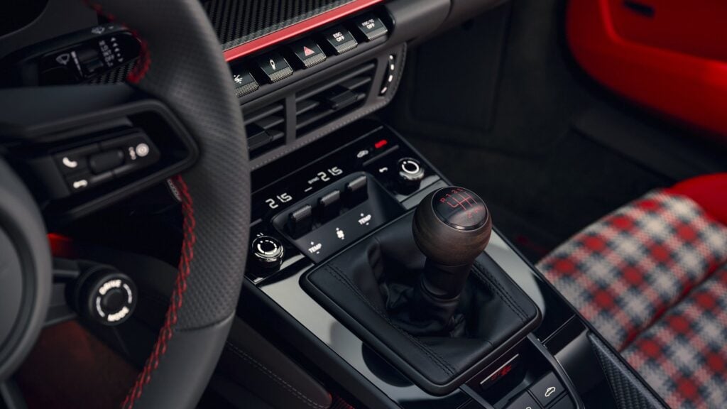 Official Porsche photo of the walnut gear knob with Pyro Red shift pattern in the 2027 Porsche 911 GT3 S/C Street Style Package interior