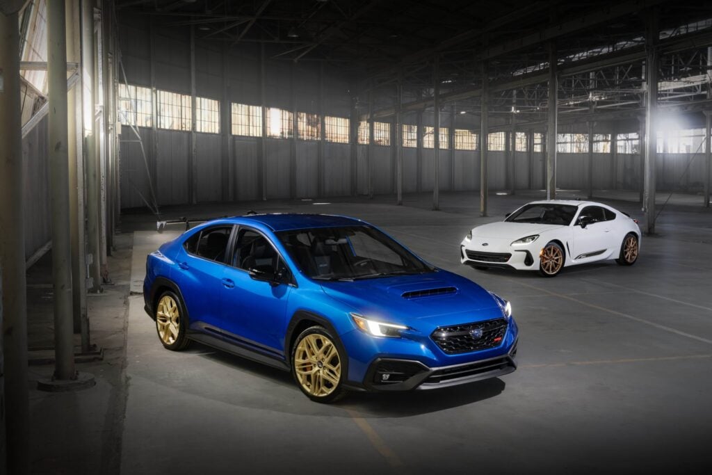 Official Subaru photo of the World Rally Blue 2027 Subaru WRX GD25 and the Ceramic White 2027 Subaru BRZ ZC15 in a warehouse