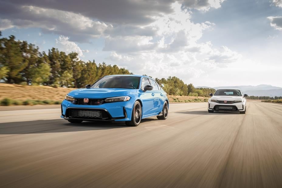 Official Honda photo of Boost Blue and Championship White 2027 Civic Type R hatchbacks on the road