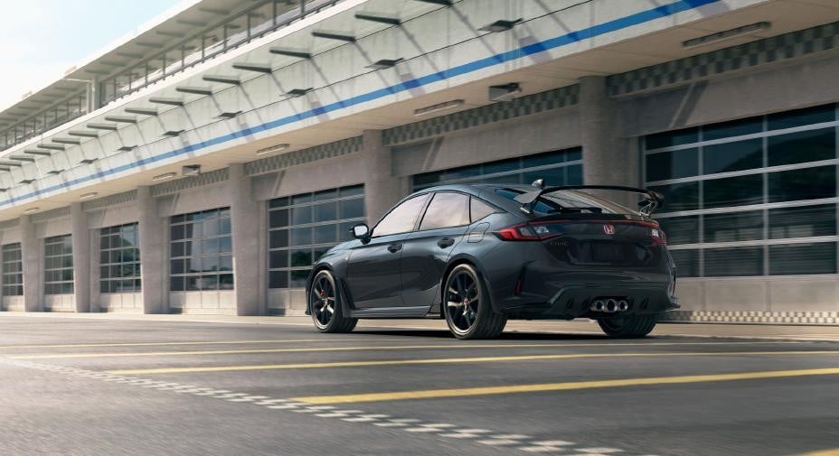 Official Honda photo of a Meteorite Gray 2027 Civic Type R rear three-quarter in a pit lane