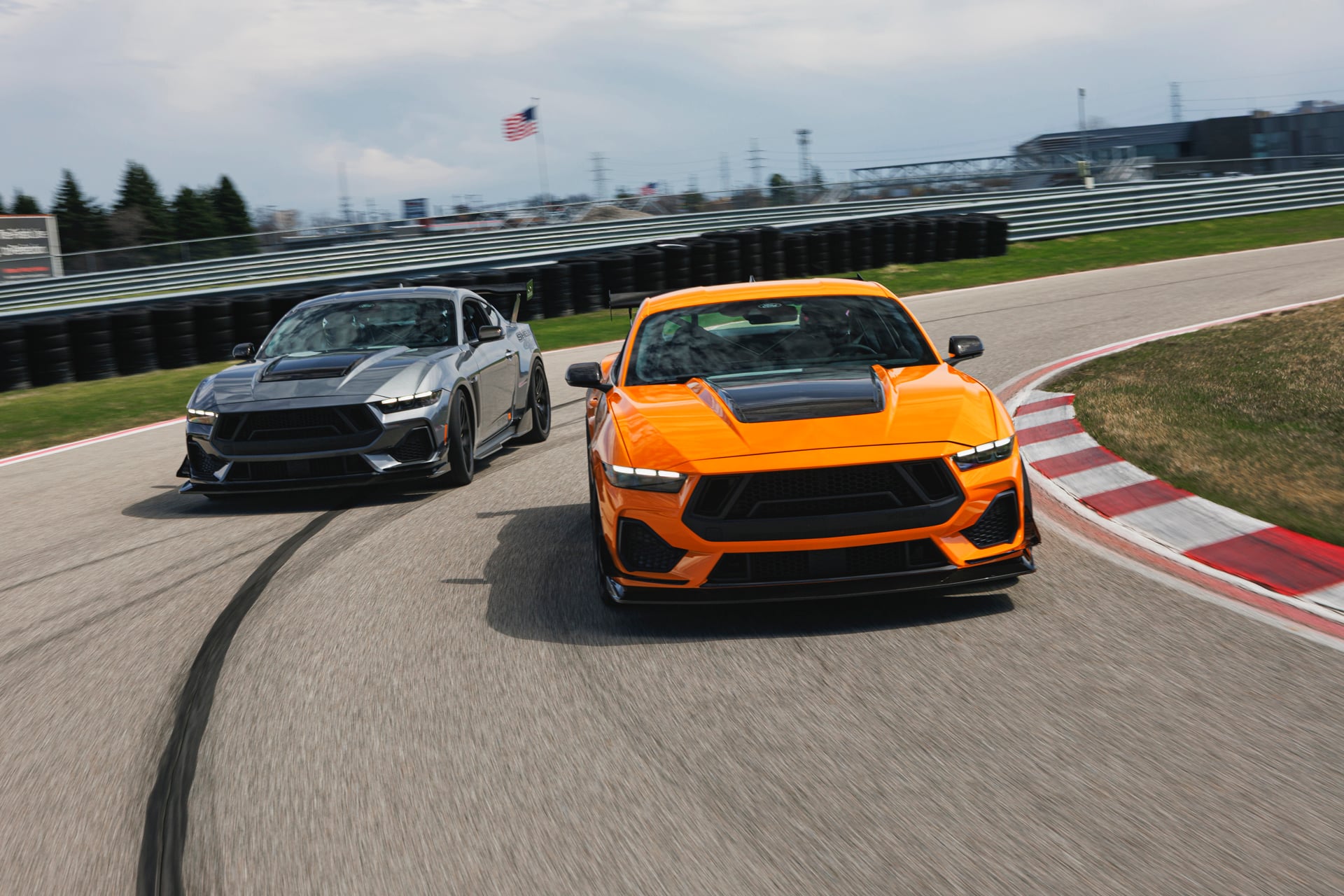 Official Shelby photo of orange and gray 2026 Shelby GT350/TA cars running together on track