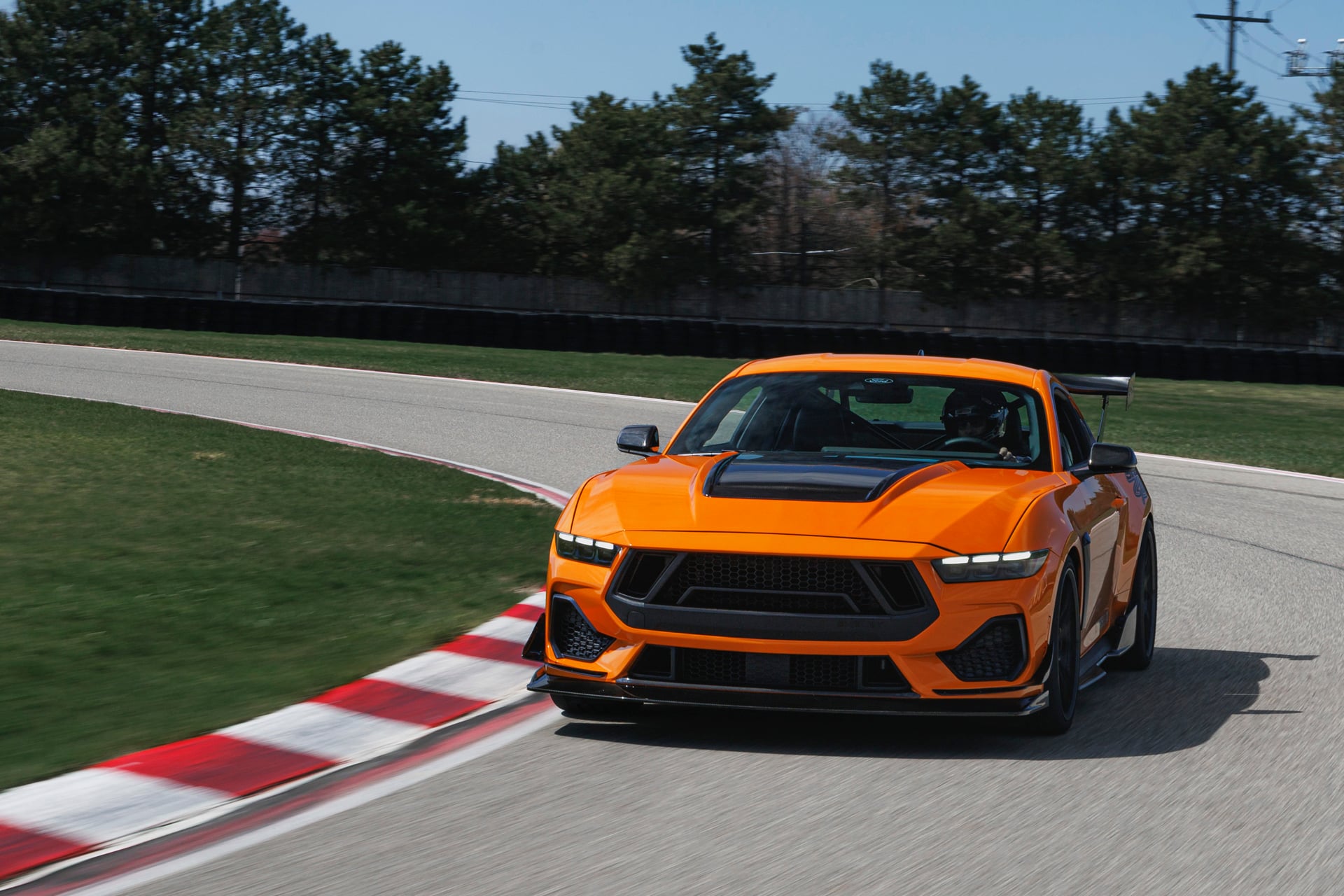 Official Shelby photo of an orange 2026 Shelby GT350/TA cornering on track