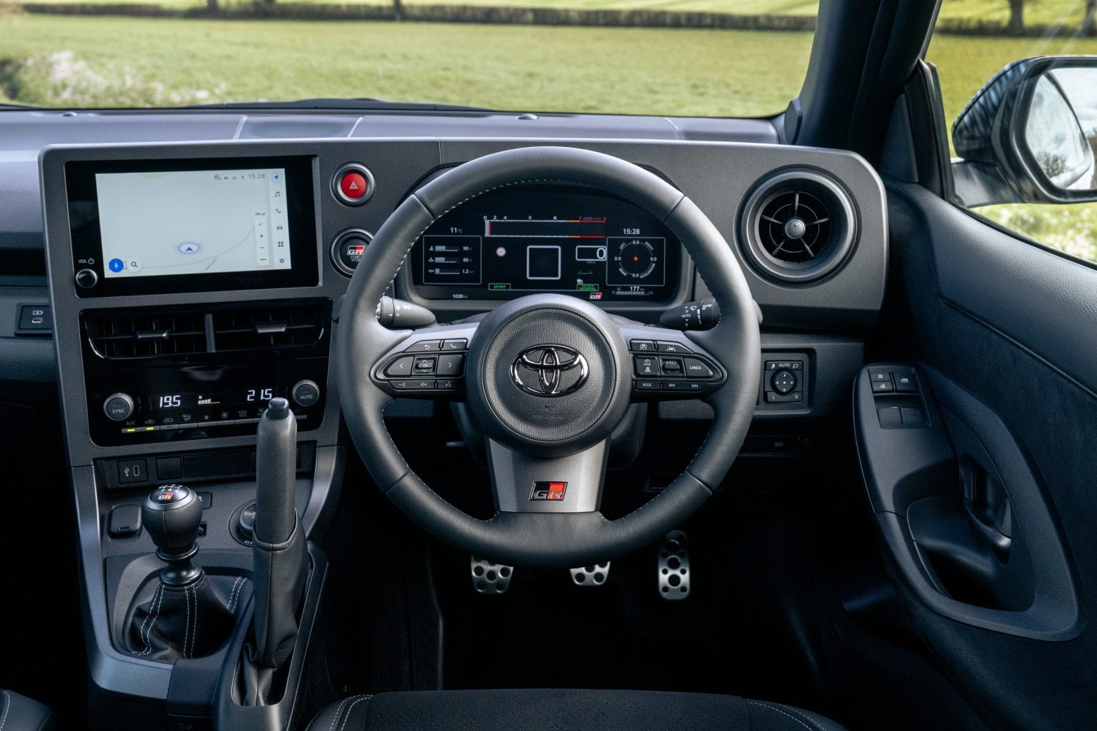 Cockpit of the 2026 Toyota GR Yaris Aero Performance with six-speed manual shifter and vertical handbrake. Image courtesy of Toyota (GB).