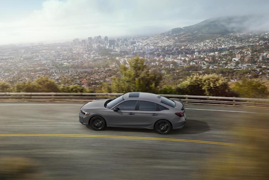 Official Honda photo of a white 2026 Civic Si side profile on a canyon road