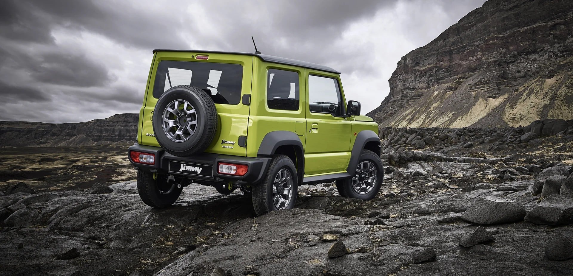 Suzuki Jimny rear view with spare wheel on rocky ground. Image courtesy of Suzuki Australia.